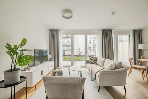 Your living room, a hub of daily activities and conversation, adorned by Arbio Designers, offering comfortable seating and a welcoming ambiance.