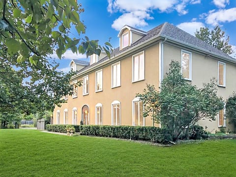 Formal front of house, surrounded by expansive yard.
