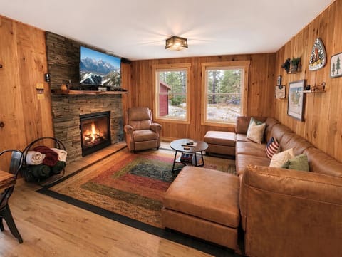 Our living room, featuring a charming fireplace, creates a snug ambiance that invites you to unwind and enjoy your time.