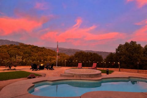 Backyard with pool, spa, fire pit, and game court