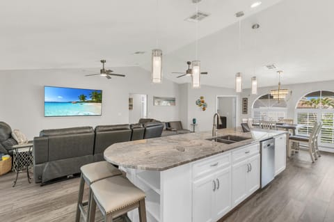 Prepare food in kitchen while interacting with family/friends, watching TV, etc.