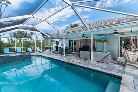 Outdoor living! Large seating areas w/ 55" TV, Weber gas grill, flows into house