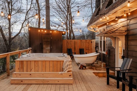 Unwind under the string lights in the warmth of the hot tub, surrounded by the beauty of nature.