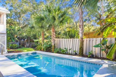 Waterway Oasis features an incredible backyard with private pool and tropical landscaping.
