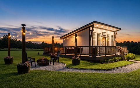 Your private sunset retreat awaits.

Unwind beneath glowing café lights, gather around the fire pit, and enjoy peaceful open views from this stylish modern getaway. With a spacious deck, serene countryside setting, and cozy evening ambiance, this is the perfect place to relax, reconnect, and make lasting memories.