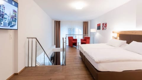 Executive Quadruple Room | Minibar, in-room safe, desk, blackout drapes