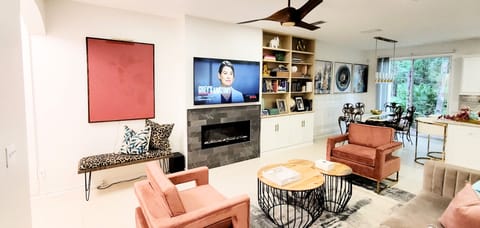 View of Living and dining areas featuring a cozy modern fireplace with dark gray