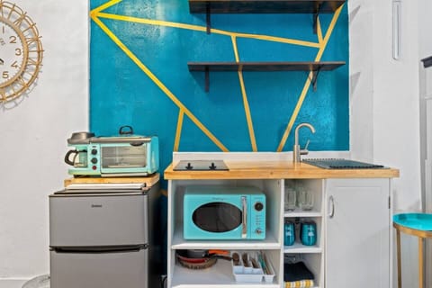 Whip up your favorite meals in this charming  kitchenette, designed with modern touches.