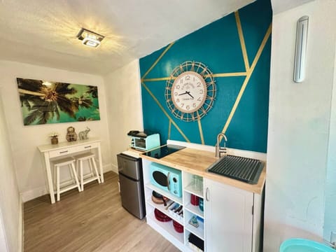 Whip up your favorite meals in this charming  kitchenette, designed with modern touches.