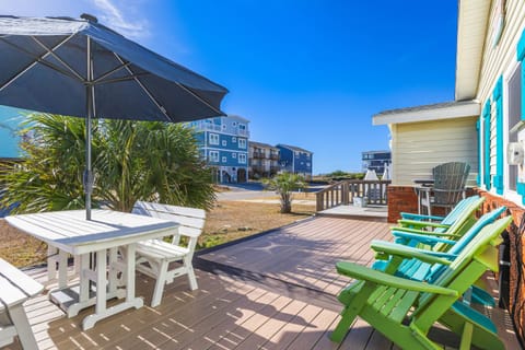 Enjoy sunny days on the deck of this charming beach house! Relax with outdoor seating, an umbrella, and beautiful coastal views.