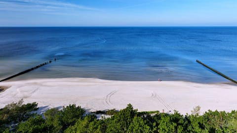 Beach nearby, white sand, windsurfing, sailing