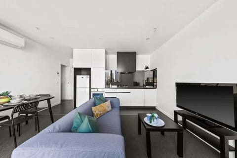 A living area with a 2 seater couch.