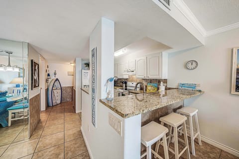 There is a dining table, perfect for enjoying a meal or playing a game, as well as additional breakfast bar seating.