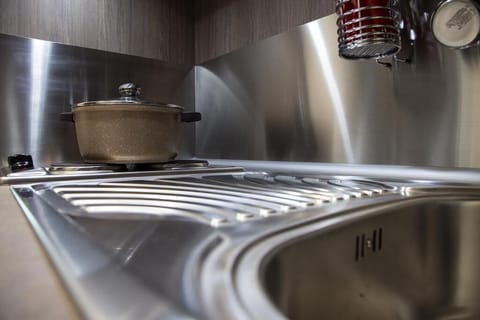 Mini-fridge, stovetop, cookware/dishes/utensils