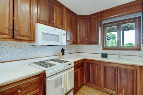 Fully equipped kitchen has a gas stove, oven, fridge, dishwasher, and microwave