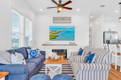 Stylish & Comfortable Living Room | Coastal Vibes Throughout Unwind in a sunlit space filled with soft textures, bold blues, and island décor — ideal for evenings i