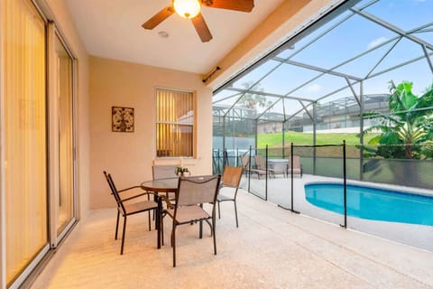 Relax on the private patio with a pool view, perfect for enjoying sunny days and balmy evenings.