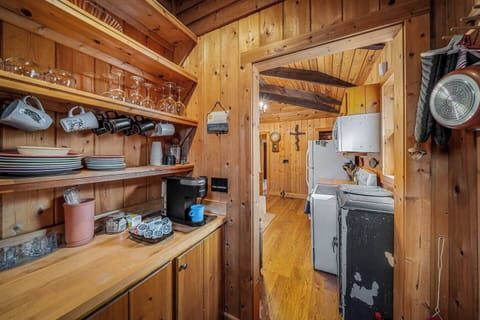 Coffee station and pantry with a Keurig coffee maker and a starter coffee kit, including K-Cups, sugar, and creamer.