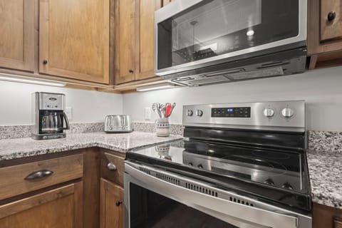 Kitchen - The fully stocked kitchen features a traditional coffee maker for brewing that 'ever so necessary' morning cup of joe.