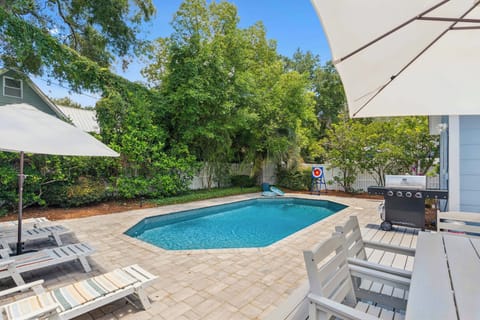 Picture yourself lounging poolside under the shade, cool drink in hand, surrounded by lush greenery and total privacy. Your private backyard oasis awaits, complete with sun loungers, a grill for evening cookouts, and even a dartboard for friendly competiti