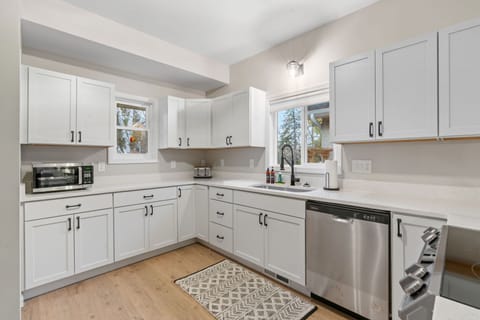 Your fully equipped kitchen awaits with sleek white cabinets, modern appliances, and everything you need to create memorable meals together.