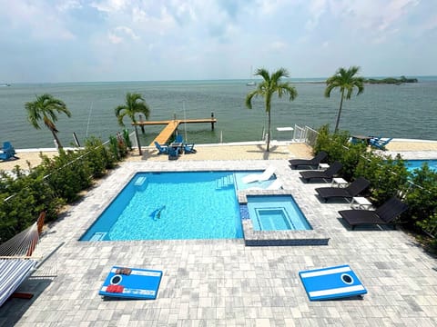 Waterfront Luxury | Heated Pool, Spa & Dock Access Bask in the sun by the serene oceanfront pool. Enjoy the spacious sundeck, jacuzzi, and peaceful views—perfect for families or couples seeking relaxation with luxury finishes.