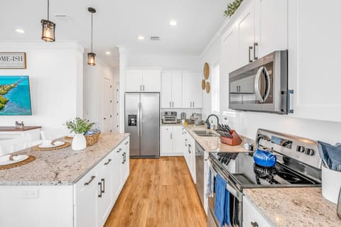 Full Gourmet Kitchen | Indoor-Outdoor Dining with Ocean Views Cook, dine, and entertain in a stylish chef’s kitchen that flows out to a breezy balcony overlooking the sea.