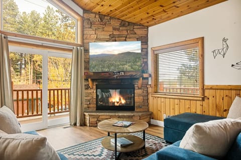 Relax by the wood burning fireplace as you watch the snow fall in the living room space.
