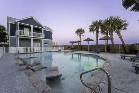 Twilight tranquility: Poolside relaxation under the evening sky.