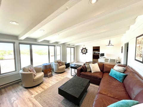 Expansive living room at daylight. Seating, views and relaxation await.