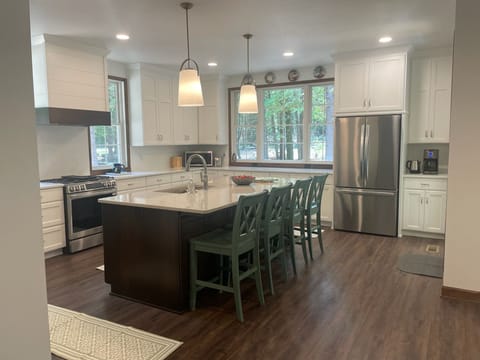 Large kitchen with island seating. Perfect for gathering together