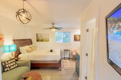Comfortable queen bed, couch sitting area with TV.