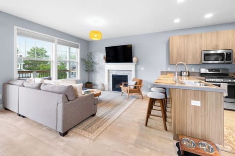Cozy living room with gas fireplace, Smart TV, board games, and deck access