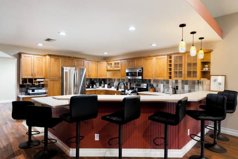 The kitchen features a convenient countertop table and barstool seating.