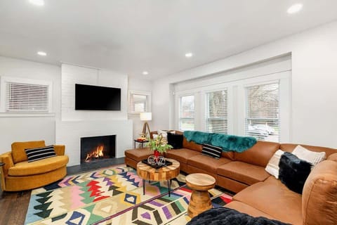 Cozy lounge with TV and natural light.
