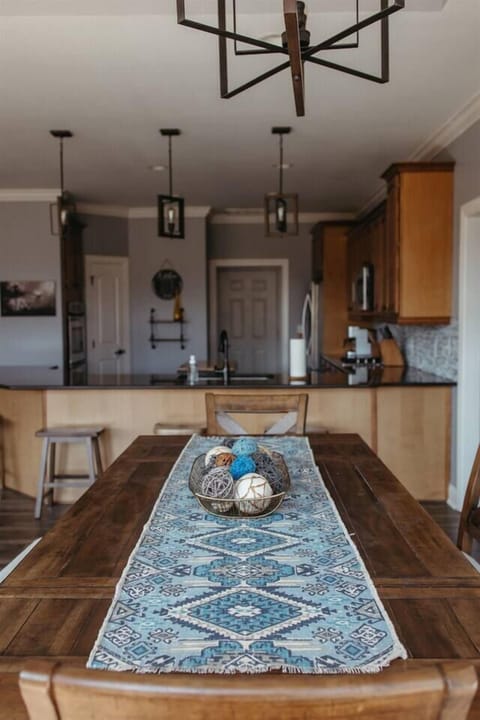 A blue and white table runner with a basket of eggs, perfect for adding a touch of elegance to your dining table.