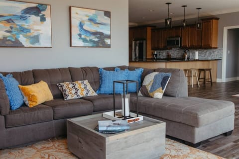 Cozy living room with gray couch and blue accents.