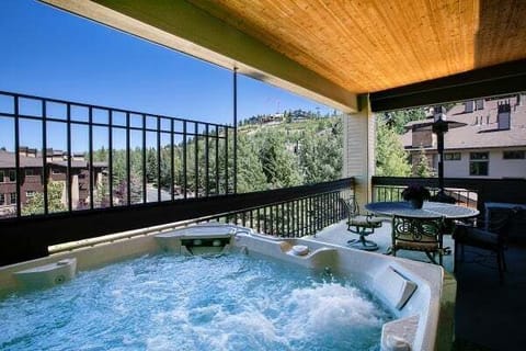 Private covered deck with hot tub and mountain views
