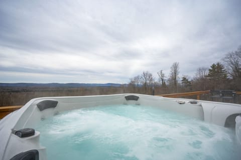 Unwind in the outdoor hot tub while soaking in breathtaking mountain views and vibrant sunsets. A perfect spot to relax and recharge in total serenity.