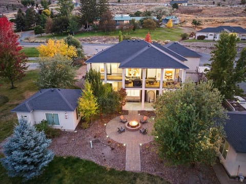 Back view of the home highlighting large second-level balconies and gathering space below.
