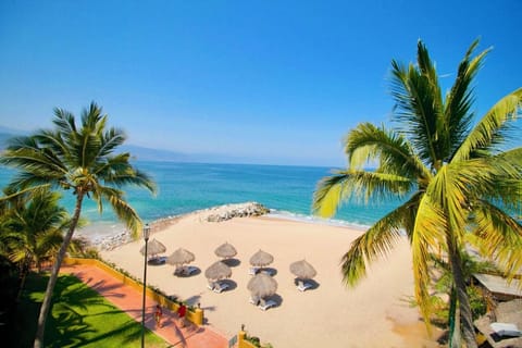 On the beach, white sand, sun loungers, beach umbrellas