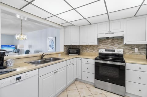 Fully stocked kitchen with new stainless steel appliances.