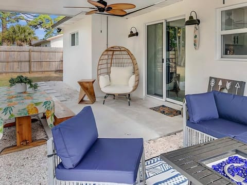 Covered back patio.  Firepit, cornhole, and hammock.