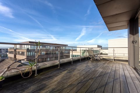 A spacious wrap-around balcony featuring outdoor seating, available during the spring and summer months.