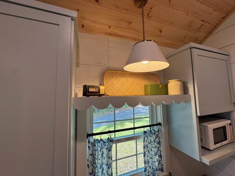 The custom cabin kitchen has Maine charm with modern amenities.