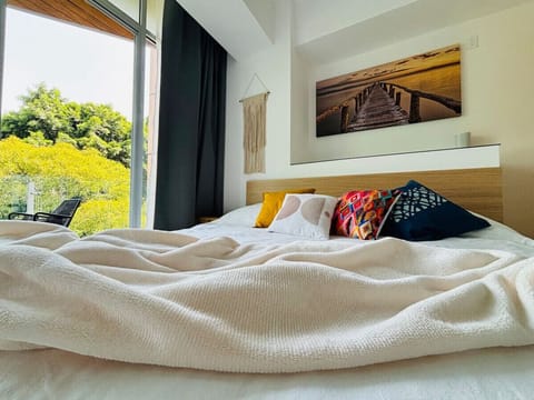 Wake up refreshed in this spacious, sunlit room featuring a plush king-sized bed, perfect for restful nights and rejuvenating mornings.