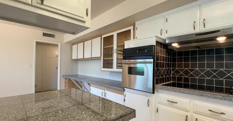 Kitchen wall with oven/stove & pantry storage