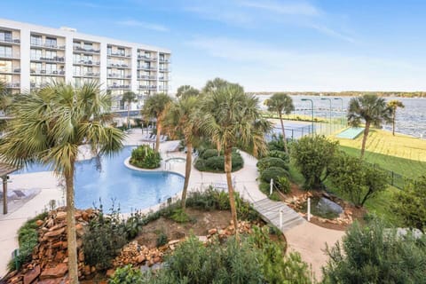 Your view from the balcony: A clear layout of the resort's amenities. From here, it’s a straightforward walk to the pool, tennis courts, and the calm waters of Little Lagoon. No crowded high-rise views—just a reliable, open space to breathe.