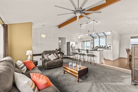 Open Concept Great Room has additional seating at the kitchen island and comfortable reclining sofa and chair.