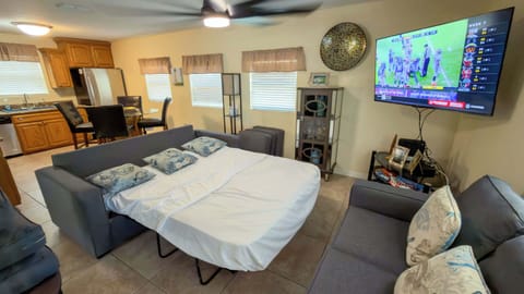 Versatile Sleeper Sofa Media Den
Pull-out queen sofa bed + 55" TV for movie nights or extra guests! Open to kitchen, fan-cooled in sunny yellow tones. Family-friendly at 113 E Pompano St—beach, harbor & SpaceX nearby. 